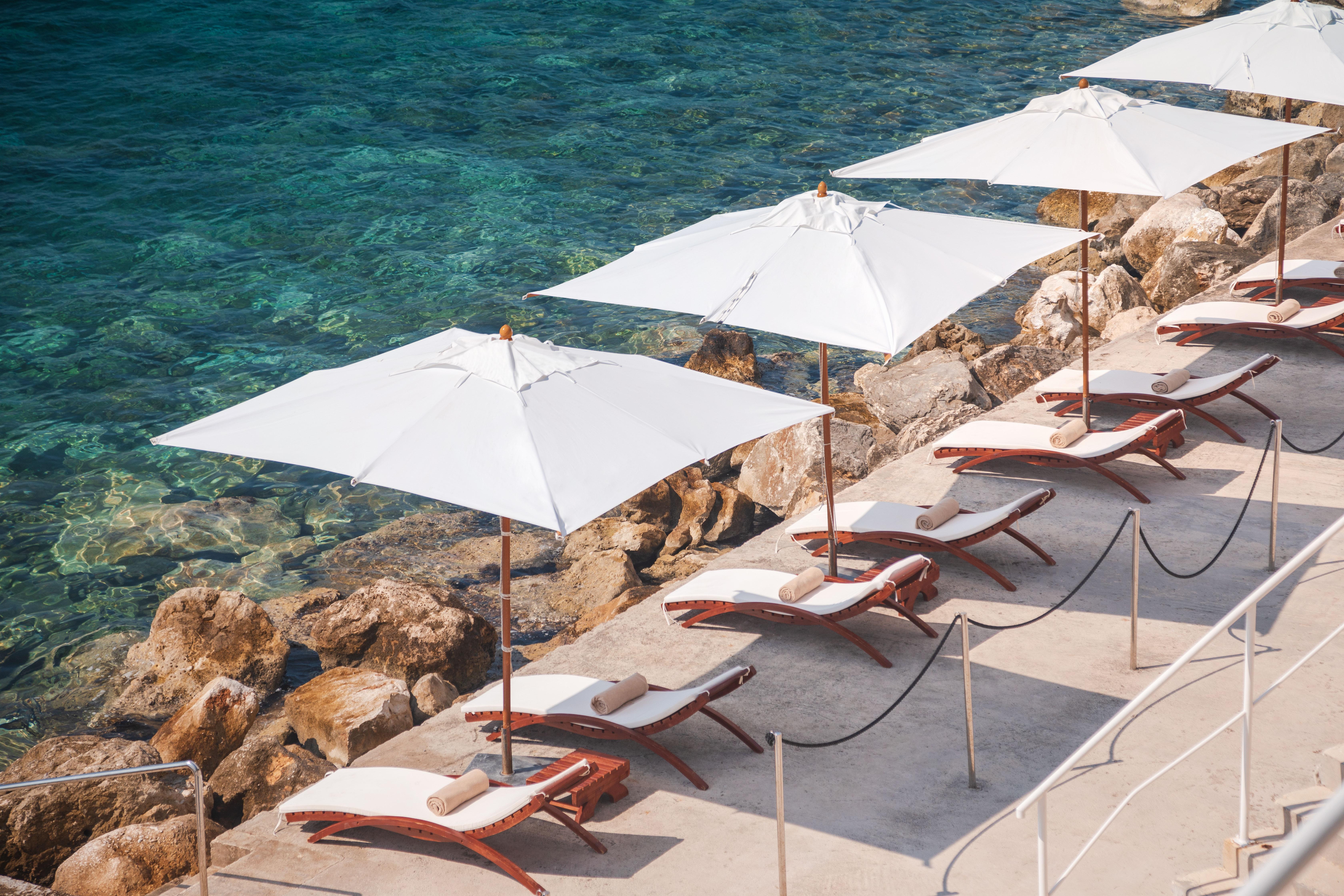 Sun Gardens Dubrovnik Hotel Exterior photo Beach chairs and umbrella